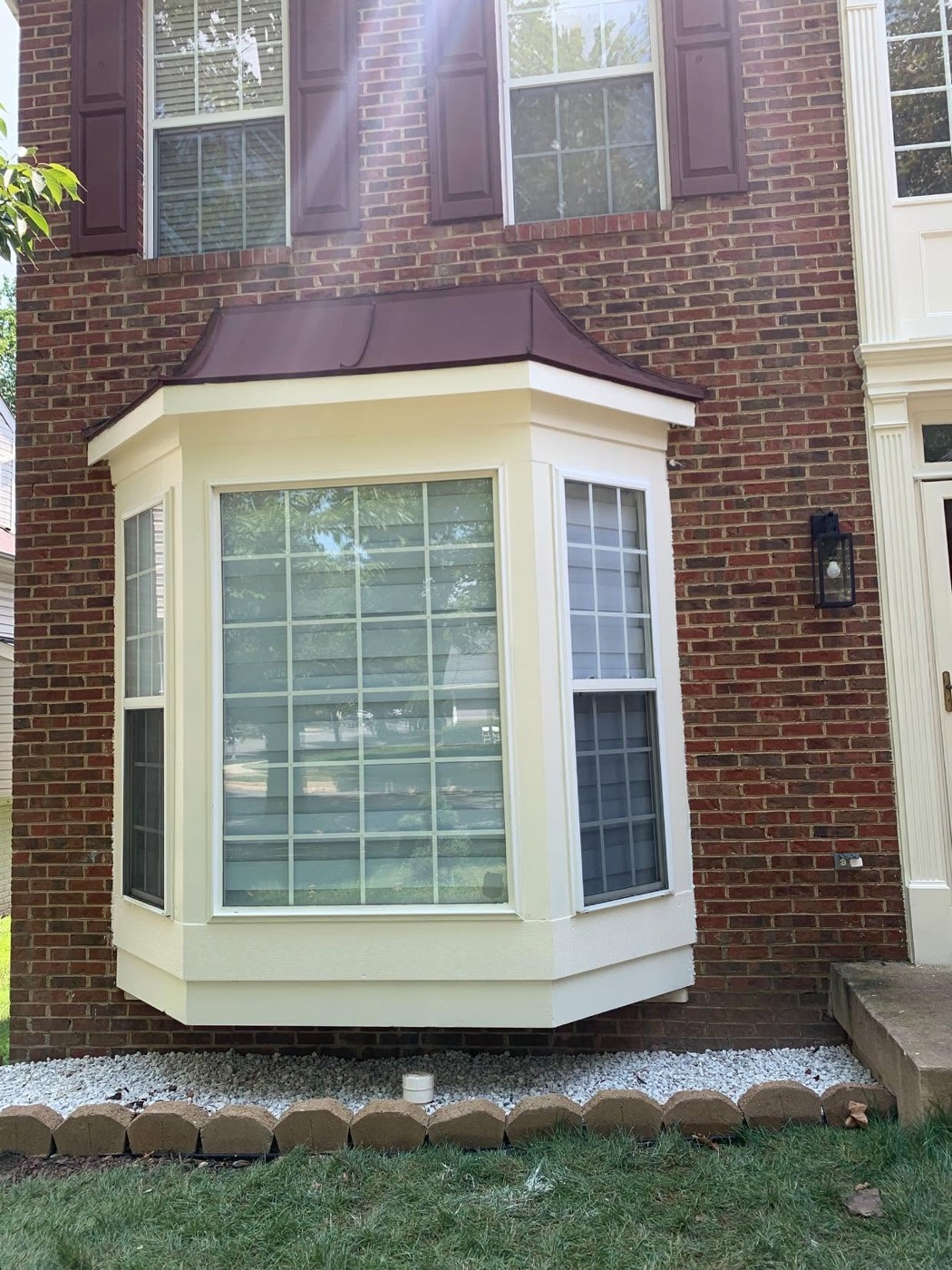 Rebuilt bay window with new trim and roof cap