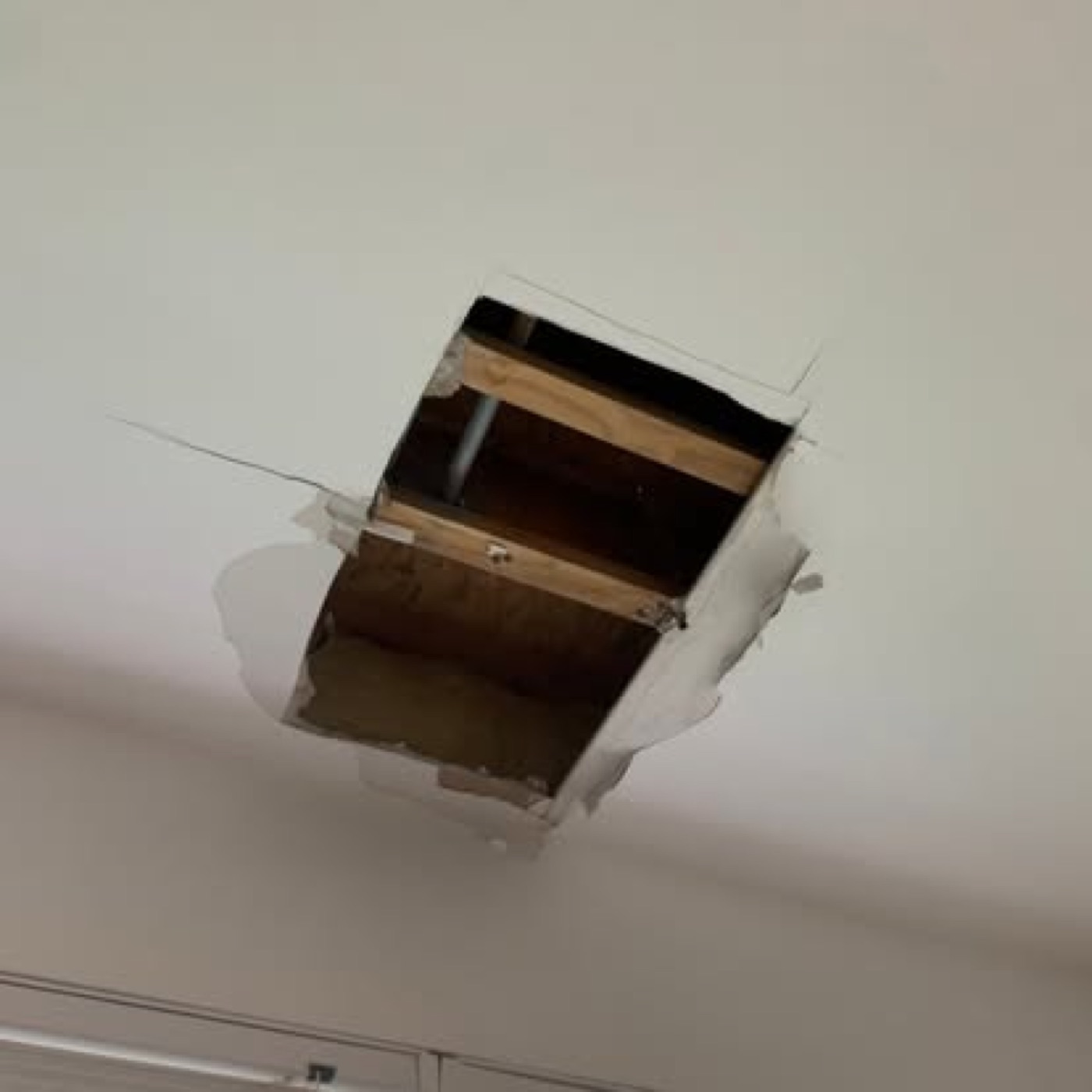 Large hole in ceiling exposing joists
