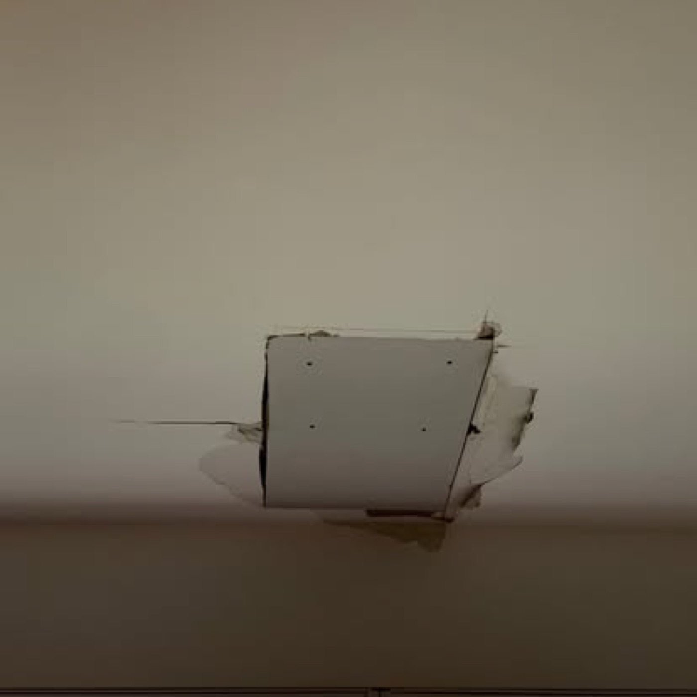 New drywall patch fitted into the ceiling opening